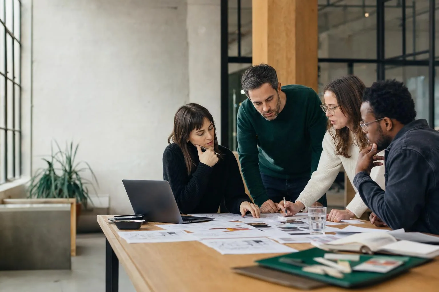 Product team discussing priorities around a shared table
