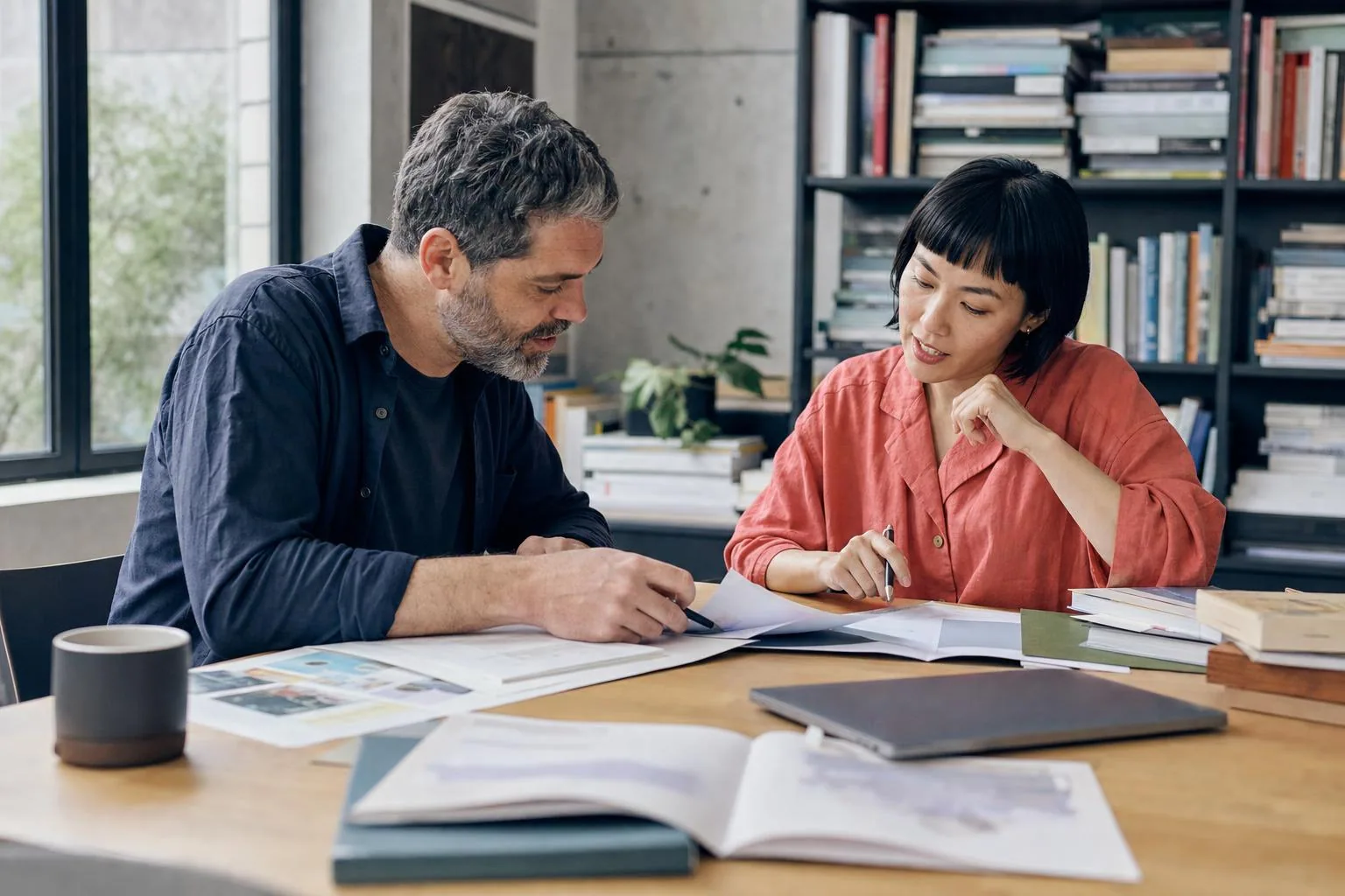 Two educators planning course materials together