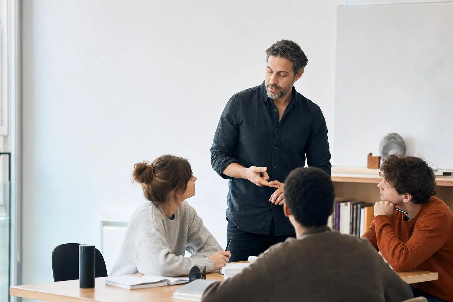 Teacher guiding students in an active classroom